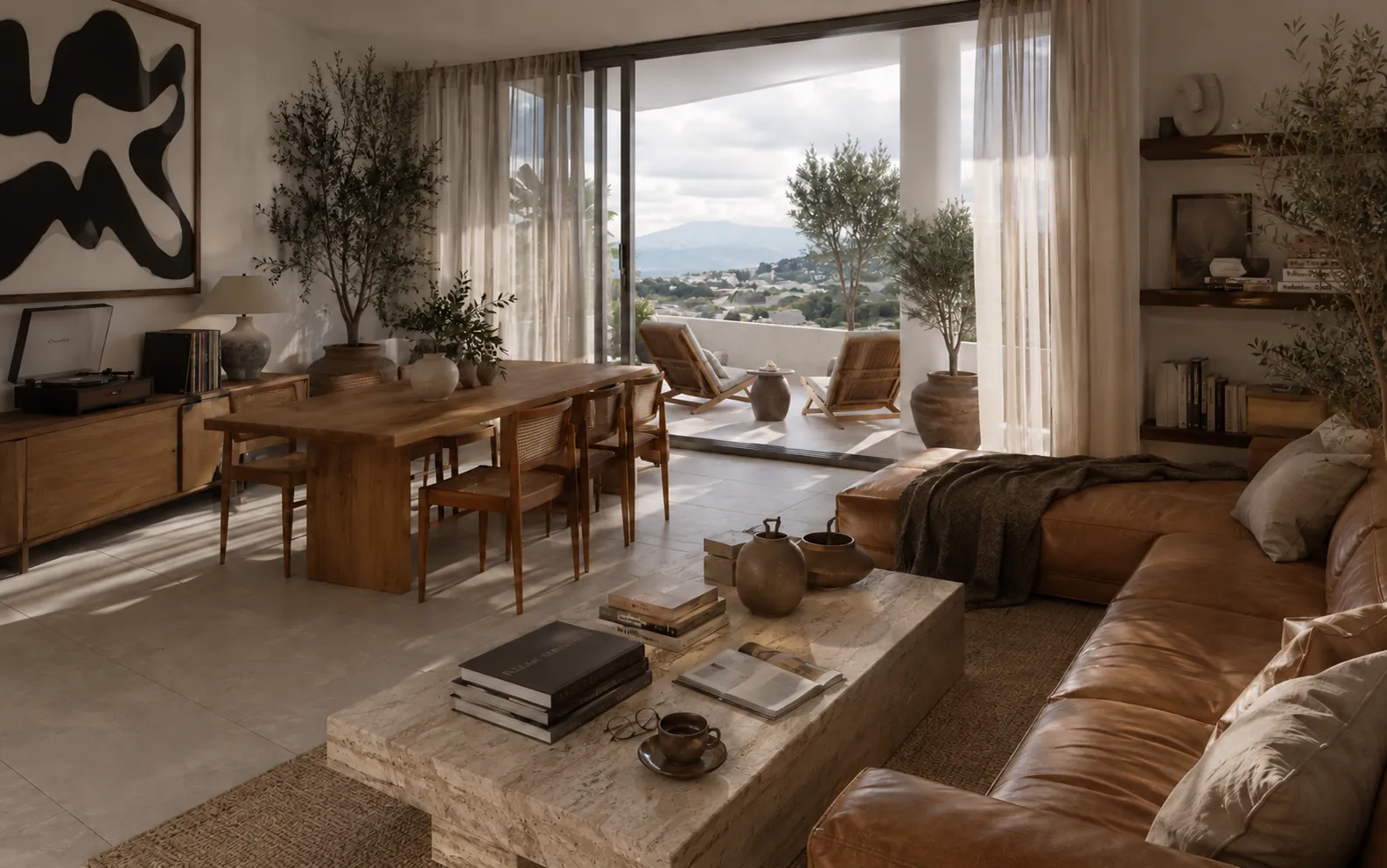 Sala de un piso alto de Miravett abierta hacia la terraza, con luz de día y vista al valle.